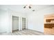 Bedroom featuring light wood flooring, a ceiling fan, and an open closet at 1740 Palm Rd, Ormond Beach, FL 32174