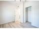 Bedroom featuring light wood flooring, an open closet, and a doorway at 1740 Palm Rd, Ormond Beach, FL 32174