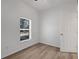 Small bedroom featuring light wood flooring, a window, and a white closet door at 1740 Palm Rd, Ormond Beach, FL 32174