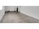 Empty garage with concrete floor and double doors at 1740 Palm Rd, Ormond Beach, FL 32174