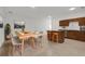 Open-concept kitchen and dining area with dark wood cabinets and modern appliances at 1740 Palm Rd, Ormond Beach, FL 32174