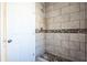 Updated shower with tile surround and pebble accents at 1740 Palm Rd, Ormond Beach, FL 32174