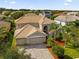 Two-story house with a three-car garage and landscaped yard at 3814 Golden Feather Way, Kissimmee, FL 34746