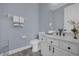 Powder room with white vanity and black accents at 3814 Golden Feather Way, Kissimmee, FL 34746