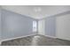 Well-lit bedroom with hardwood floors and neutral walls at 3814 Golden Feather Way, Kissimmee, FL 34746