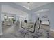 Open concept dining area with glass table and modern chairs at 3814 Golden Feather Way, Kissimmee, FL 34746