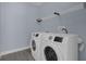 Laundry room with washer, dryer, and shelving at 3814 Golden Feather Way, Kissimmee, FL 34746