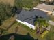 Aerial view showcasing home's exterior, landscaping, and pool at 4431 Rock Hill Loop, Apopka, FL 32712