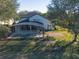 Exterior view of the backyard, lanai with pool and fence line of a lovely home at 4431 Rock Hill Loop, Apopka, FL 32712