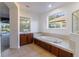 Bathroom with garden tub, double vanity, and large mirror at 4431 Rock Hill Loop, Apopka, FL 32712