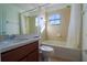 Bathroom featuring tile flooring, a shower with tub, a large mirror and natural light at 4431 Rock Hill Loop, Apopka, FL 32712