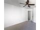 Simple bedroom with ceiling fan, carpet flooring, and an open door to hallway at 4431 Rock Hill Loop, Apopka, FL 32712