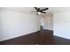 Bedroom with hardwood floors, ceiling fan, and view into the closet at 4431 Rock Hill Loop, Apopka, FL 32712