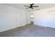 Neutral bedroom featuring a ceiling fan, carpet, an open door, and an adjacent closet at 4431 Rock Hill Loop, Apopka, FL 32712