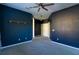 Spacious bedroom with dark blue walls, carpet, and ceiling fan at 4431 Rock Hill Loop, Apopka, FL 32712