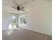 Bright bedroom with carpet flooring, large windows, and ceiling fan at 4431 Rock Hill Loop, Apopka, FL 32712