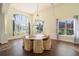 Bright dining room with hardwood floors, ample seating, and natural lighting at 4431 Rock Hill Loop, Apopka, FL 32712