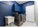 Laundry room featuring a utility sink, cabinets, and dark stainless steel washer and dryer at 4431 Rock Hill Loop, Apopka, FL 32712