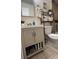 Functional bathroom with updated vanity and storage shelving at 606 Northlake Dr # 606, Sanford, FL 32773