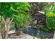 Backyard view featuring a custom gazebo and beautiful landscaping with mature trees, bushes and a wood fence at 1269 Buccaneer Ave, Deltona, FL 32725