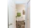 Inviting bathroom featuring marbled floors, a toilet, and a decorative towel, creating a functional and stylish space at 1269 Buccaneer Ave, Deltona, FL 32725