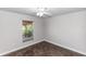 A bright bedroom featuring a ceiling fan, natural light, and stylish marbled floors, creating a warm atmosphere at 1269 Buccaneer Ave, Deltona, FL 32725