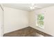 This bright bedroom features a ceiling fan, closet, and stylish marbled floors, offering a cozy retreat at 1269 Buccaneer Ave, Deltona, FL 32725