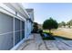 Front exterior of the property with manicured landscaping and side screen door at 1269 Buccaneer Ave, Deltona, FL 32725