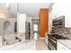 Well-lit kitchen boasts granite countertops, modern appliances, and a view into the next room at 1269 Buccaneer Ave, Deltona, FL 32725