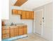 Kitchenette featuring wooden cabinetry, a stainless steel sink, and a tile floor at 1269 Buccaneer Ave, Deltona, FL 32725