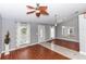Open living room with wood flooring, a ceiling fan, and natural light from the front door at 1269 Buccaneer Ave, Deltona, FL 32725