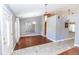 Inviting living room features wood floors and plenty of natural light from the entryway at 1269 Buccaneer Ave, Deltona, FL 32725