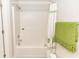 A clean white shower with a shower curtain, storage space, and a towel, adding a touch of comfort and style at 1269 Buccaneer Ave, Deltona, FL 32725