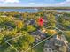 Aerial view of the property near a serene lake, surrounded by lush greenery and upscale homes at 17429 Cobblestone Ln, Clermont, FL 34711