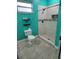 Teal bathroom with a shower and toilet at 3193 W Central Blvd, Orlando, FL 32805