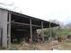Interior view of the barn with exposed rafters and various storage items at 3555 E Johnson Ave, Haines City, FL 33844