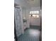 Blue tiled bathroom with a shower/tub combination and a single-sink vanity at 3555 E Johnson Ave, Haines City, FL 33844
