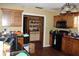 Outdated kitchen has wood cabinets, black appliances, and tile floors at 3555 E Johnson Ave, Haines City, FL 33844