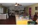 Open living room with a brick fireplace, tile floors, and disorganized furniture at 3555 E Johnson Ave, Haines City, FL 33844