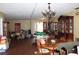 Open-concept living room and dining area with tile flooring and a traditional chandelier at 3555 E Johnson Ave, Haines City, FL 33844