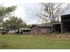 An image shows several small wooden outbuildings located in a grassy yard at 3555 E Johnson Ave, Haines City, FL 33844