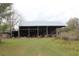 A barn with a shed on a grassy field, offering ample outdoor storage and rural charm at 3555 E Johnson Ave, Haines City, FL 33844