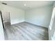 Bedroom featuring modern gray wood-look flooring and a closet at 6421 Sw 151St Loop, Ocala, FL 34473