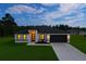Charming single-story home featuring a well-manicured lawn and a modern garage door at 6421 Sw 151St Loop, Ocala, FL 34473