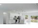 Bright and open kitchen featuring stainless appliances and quartz countertops, with a sliding glass door at 6421 Sw 151St Loop, Ocala, FL 34473