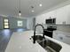 Open-concept kitchen with an island featuring a modern black faucet and sink at 6421 Sw 151St Loop, Ocala, FL 34473
