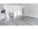 Expansive kitchen with wood-look floors, a quartz island, and modern pendant lighting at 6421 Sw 151St Loop, Ocala, FL 34473