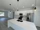 Bright kitchen with white cabinets, stainless steel appliances, and a quartz-topped island at 6421 Sw 151St Loop, Ocala, FL 34473