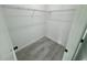 A compact walk-in closet features light-grey, wood-look floors and shelving at 6421 Sw 151St Loop, Ocala, FL 34473