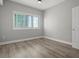 Bright bedroom with hardwood floors and large window at 100 S Eola Dr # 608, Orlando, FL 32801